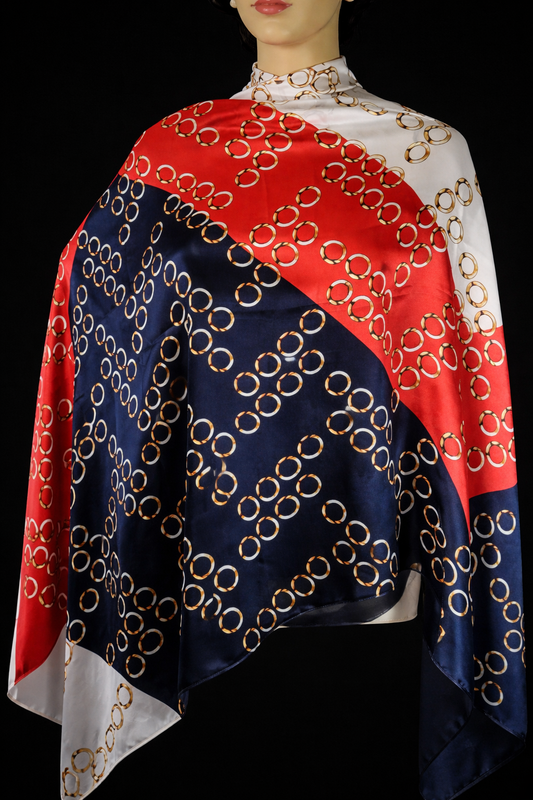 Luxury silky-feel scarf with bold red, navy, and white tones, finished with an elegant gold chain print.